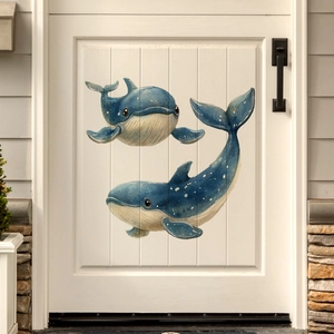 Detailed view of hand-painted blue whale wall stickers on a classic white wooden door