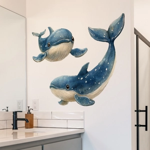 Detail of blue watercolor whale wall stickers on a clean white bathroom wall background