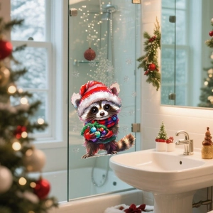 Detail of Christmas raccoon window sticker with red hat and scarf on glass surface