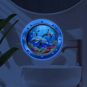 Close-up of 3D circular porthole wall light showing glowing dolphins and coral reefs