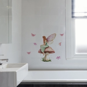 Luminous flower fairy on mushroom wall decal shown in a bright white bathroom scene