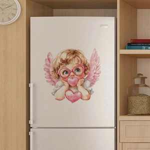 Close-up of a cute luminous angel sticker with pink wings on a white refrigerator surface