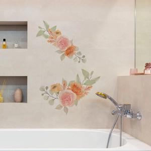 Stickers muraux fleurs aquarelles imperméables en orange et rose sur un mur carrelé