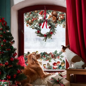 Detailed Christmas window stickers showing squirrels and pine branches in cozy room decor