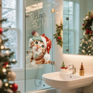 Christmas window cling featuring an orange cat in a holiday hat on a glass shower door