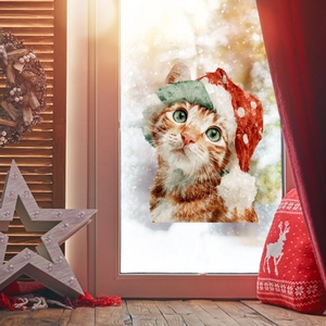 Detail of Christmas window sticker featuring a cute watercolor ginger cat with a holiday hat