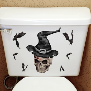 Autocollants d'Halloween tête de mort et chauves-souris sur un réservoir de WC blanc