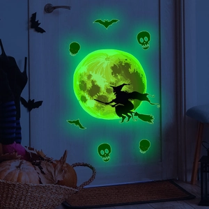 Luminous green Halloween wall stickers featuring a moon, witch, and bats on a wooden door