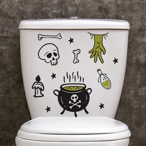 Close-up of Halloween toilet stickers with skull, zombie hand, and glowing potion bottle