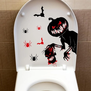 Detailed view of spooky Halloween pumpkin man and bat stickers on a white toilet lid