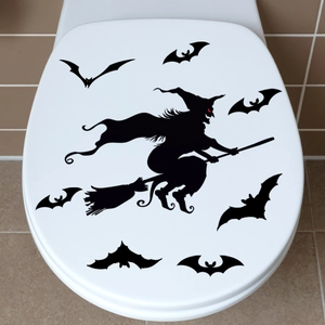 Luminous Halloween witch and bats decal applied to a white toilet lid surface