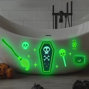 Luminous Halloween wall stickers with ghost and skull designs glowing on a bathtub surface