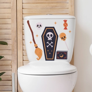 Luminous Halloween stickers with ghosts and skulls applied on a white ceramic toilet tank