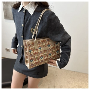 Detailed side view of the geometric checkered tote bag showing material texture and handle