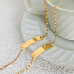 Gold plated ball chain bracelet with rectangular tags engraved Happy Forever