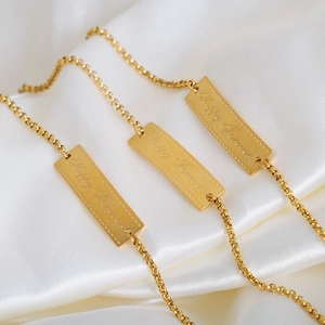 Elegant gold plated stainless steel bracelet featuring engraved Happy Forever square charm