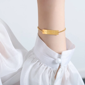 18k gold plated stainless steel curved bar bracelet featuring Happy Forever engraving