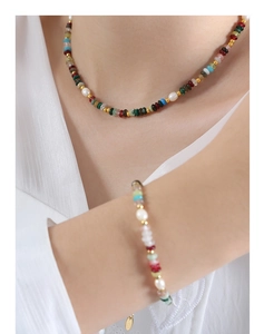 Détail de collier et bracelet en pierres colorées et perles d'eau douce sur mannequin