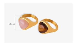 Detail of gold plated titanium rings featuring triangular tiger eye and pink quartz stones