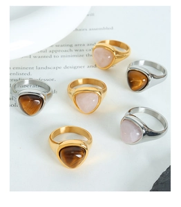 Detail of 6pcs gold and silver titanium rings with triangular tiger eye and quartz stones