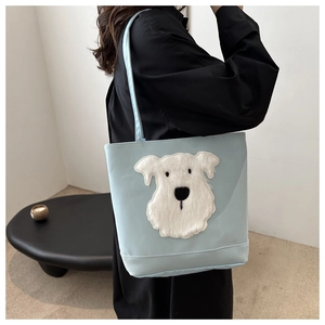 Detailed view of cute white furry dog applique on light blue casual canvas tote shoulder bag.