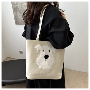 Close-up of a cream canvas tote bag featuring a cute furry schnauzer dog patch detail