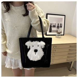 Detail of black tote bag featuring a cute white plush schnauzer motif and glossy texture