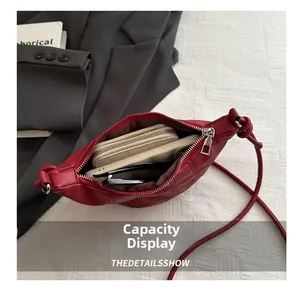 Internal capacity of dark red crescent bag with phone, wallet and sunglasses