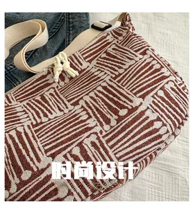Detailed close-up of brown geometric jacquard pattern fabric and cream knotted zipper pull