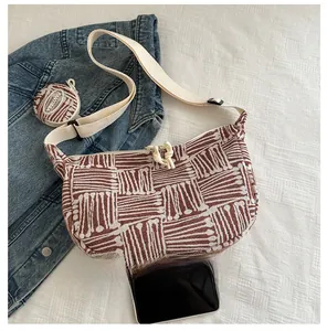 Detailed top view of a crescent canvas tote bag showing the texture and coin purse