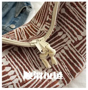 Detail of smooth YKK zippers on large jacquard tote bag with geometric pattern
