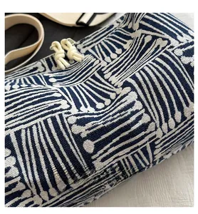 Detailed view of woven navy and white geometric pattern on a large commuter tote bag