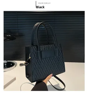 Detail of black embossed diamond pattern PU leather handbag with cylindrical handles
