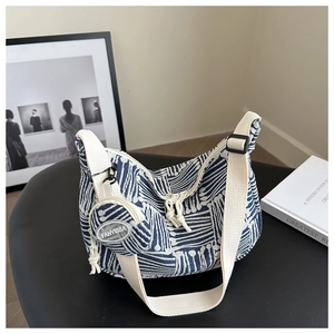 Blue and white plaid tote bag detail with wide strap and matching round coin purse charm