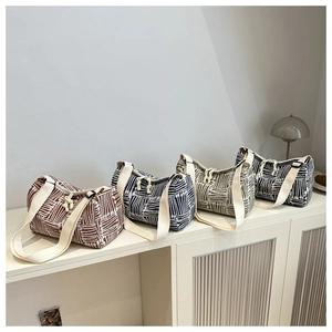 Group display of cylindrical canvas tote bags in four colors with white geometric lines