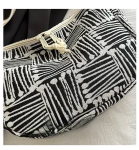 Close-up of the black and white geometric striped jacquard fabric with double zippers