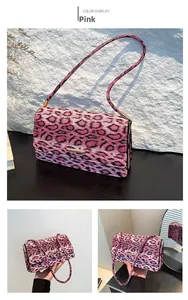Close-up of pink leopard print shoulder bag with gold metal buckle and leather strap