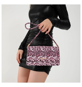 Detail of pink leopard print mini bag featuring plush texture and gold hardware accent