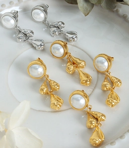 Detailed view of Baroque pearl earrings with textured 18k gold-plated metal tassels
