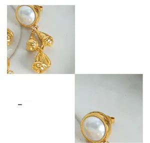 Detailed close-up of 18K gold plated titanium earring with high-gloss pearl and tassel