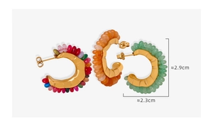Detail view of wavy gold earrings with colorful beads and 2.9cm height measurements