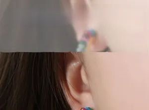 Close-up model shot of gold-plated C-shaped earrings with colorful natural stone beads