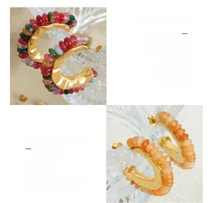 Macro shot of 18K gold plated titanium twist hoop earrings with colorful natural stone beads