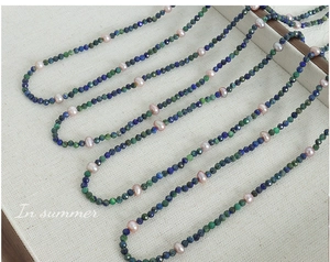 Detail of lapis lazuli beads and pink freshwater pearls on a handmade necklace