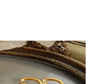 Macro detail of elegant gold C-shaped hoop earrings with a frosted matte metallic finish