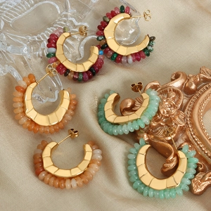 Bohemian gold hoop earrings with colorful natural stone beads on champagne fabric