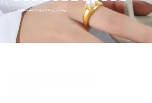 Detail showing a minimalist gold-plated titanium steel ring with a round white pearl inlay