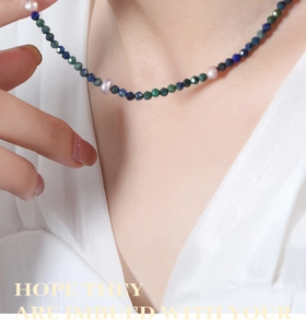 Close-up of lapis lazuli and pearl beaded necklace worn on a neck for a refined look
