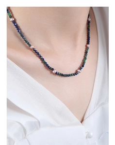 Close-up of bohemian beaded necklace with natural lapis lazuli and freshwater pearls