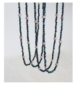 Detail of faceted lapis stone beads and irregular baroque freshwater pearls on a necklace